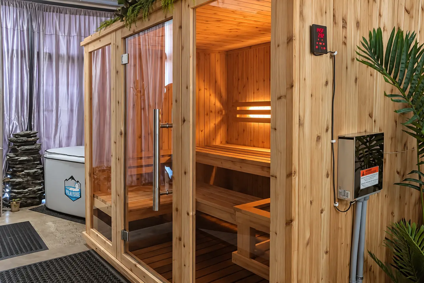Traditional wood sauna with an open glass door at Elemntal Wellness