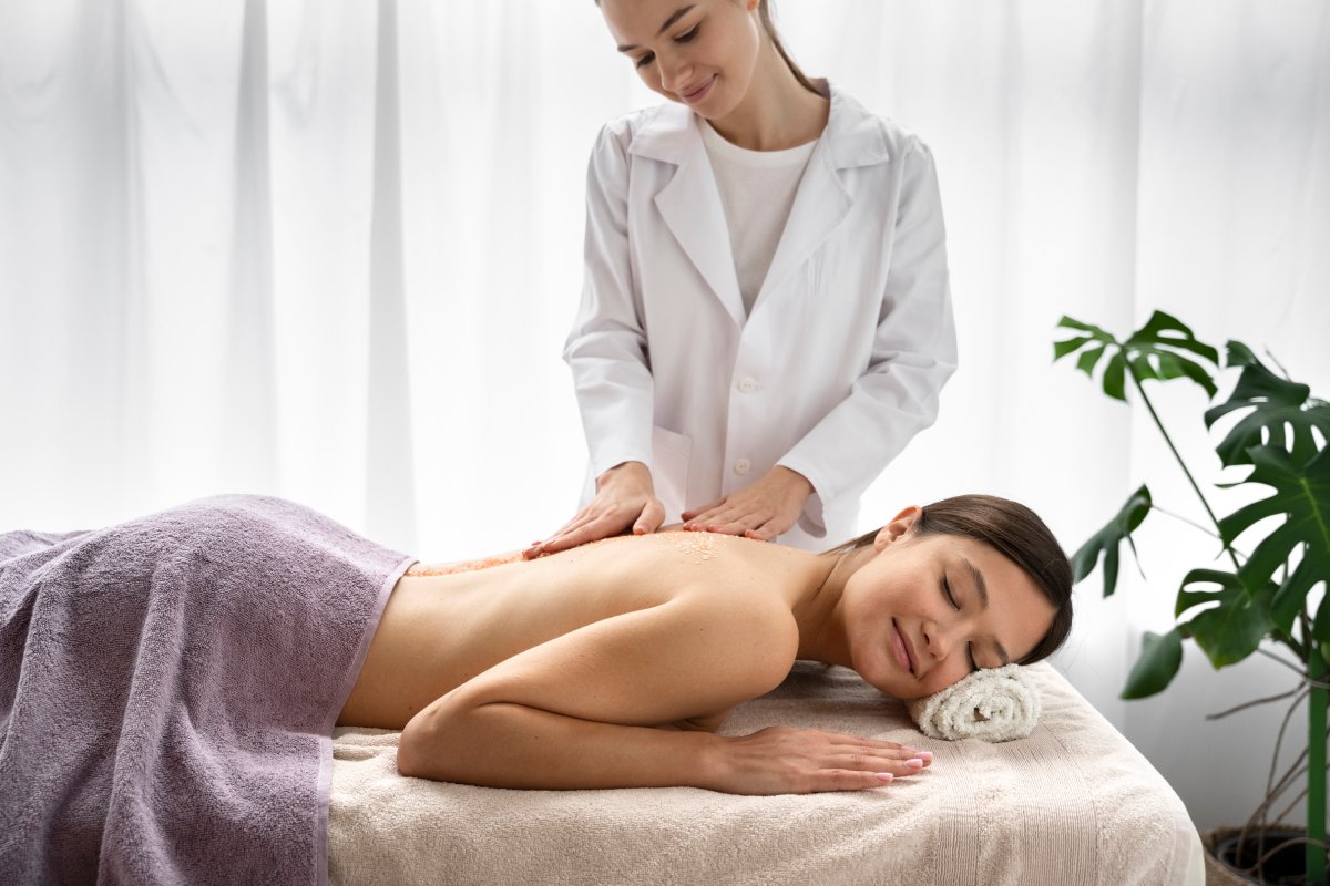 Side view woman getting massaged spa